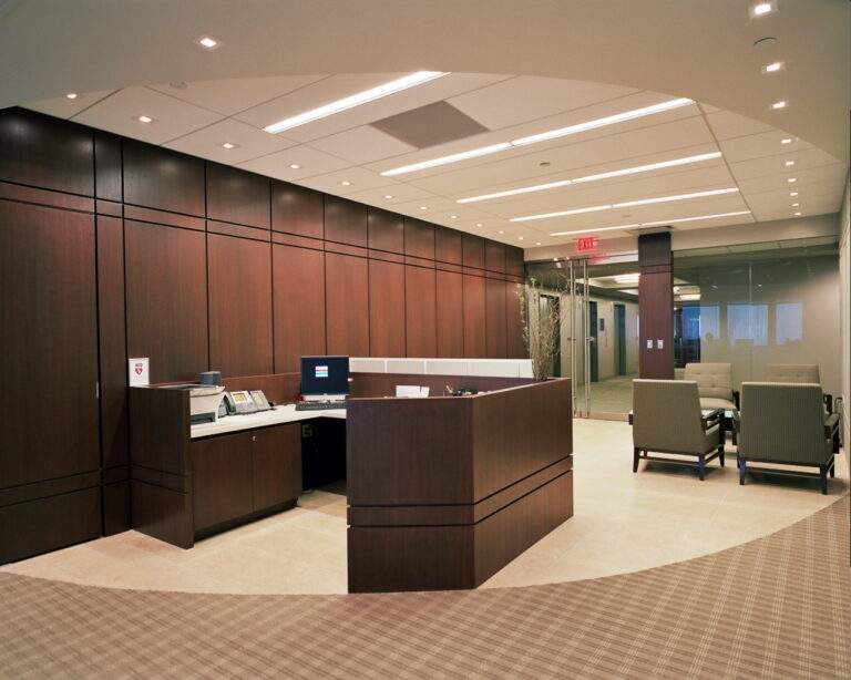 Renovated entrance area of the Friedman Kaplan office featuring modern finishes, glass entry doors, and a sleek reception design.