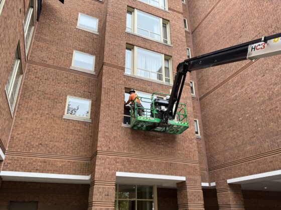 DDB Contracting crew member on a crane renovating the exterior of The Westin Princeton at Forrestal Village in Princeton, NJ.