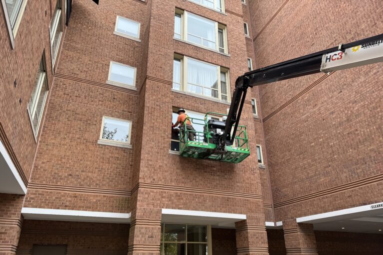 DDB Contracting crew member on a crane renovating the exterior of The Westin Princeton at Forrestal Village in Princeton, NJ.