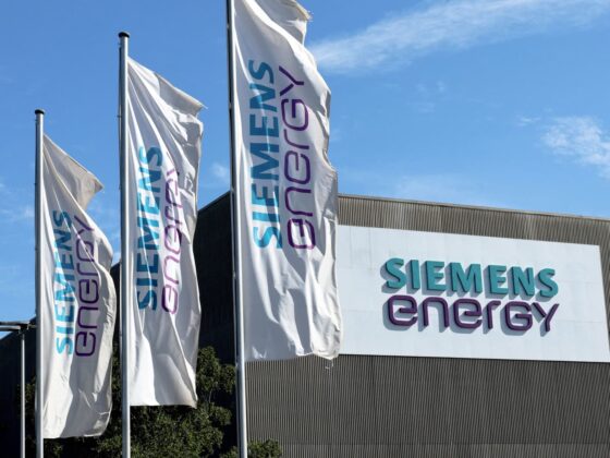 Front view of a Siemens Energy corporate office with company flags and signage.