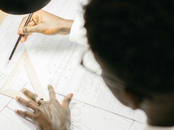 Professional reviewing architectural drawings. Value Engineering vs. Cost Cutting in commercial construction