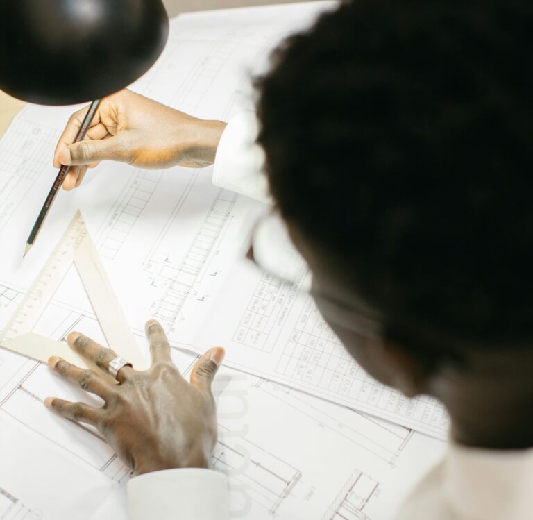 Professional reviewing architectural drawings. Value Engineering vs. Cost Cutting in commercial construction